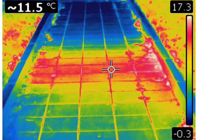 Infrared image of heated surface from underground hot water pipe. Colors represent various temperatures, defined with rainbow Celsius scale on right side of image. Temperature on upper left corner is a temperature of a point where cursor is. Photo is taken with Flir T420 infrared camera.